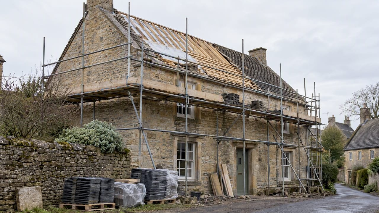 Scaffolding around a listed house during roof restoration